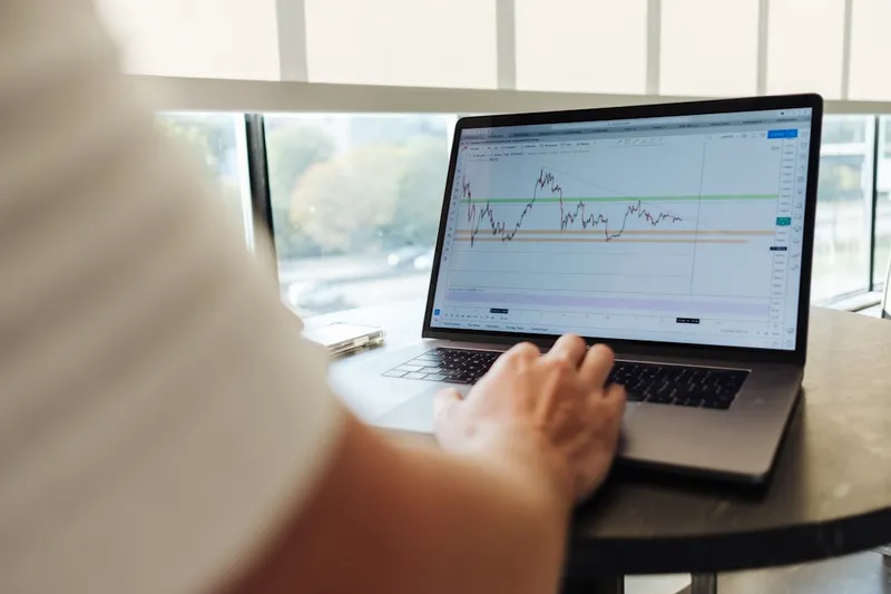 Professional using MacBook Pro for financial analysis